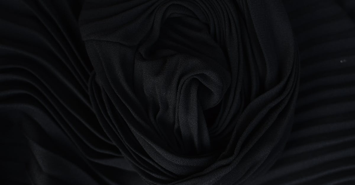 Tips for Removing Silk from Corn? - Top view of abstract background representing wavy creased black silk fabric in twilight