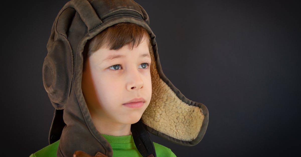 To lid or not to lid? - Boy in Green Hoodie With Brown Hat