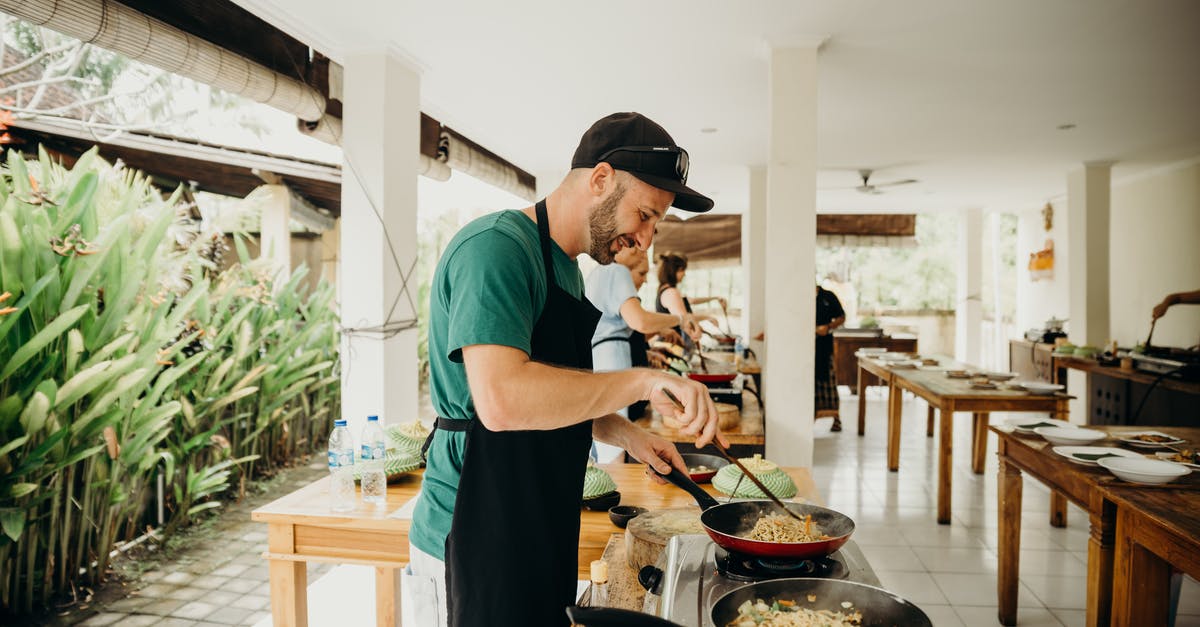 To what extent are dimpled pans interchangeable? - A Man Wearing Black Apron Cooking Food in a Cooking Competition