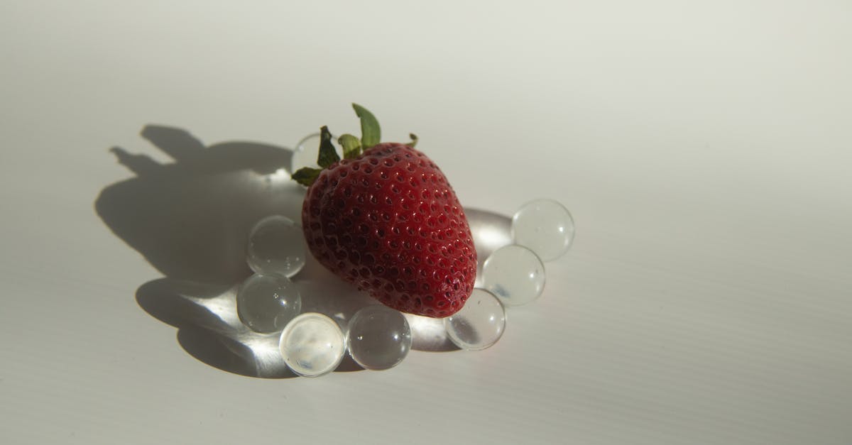 Tool for making small balls of sticky food - Sweet strawberry placed on small glass balls