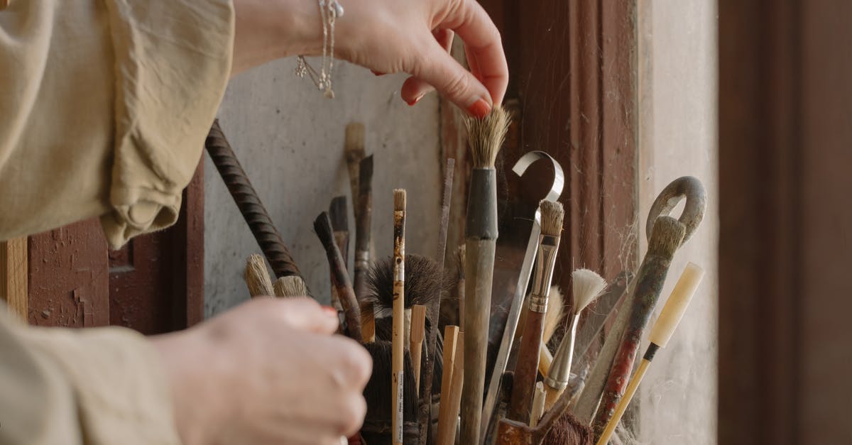 Tools used to spread oil for crêpes - Person Holding Brown Wooden Handle Paint Brush