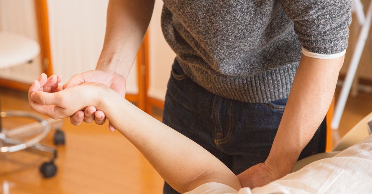 Tortilla press geometry problems - Crop chiropractor massaging hand of patient