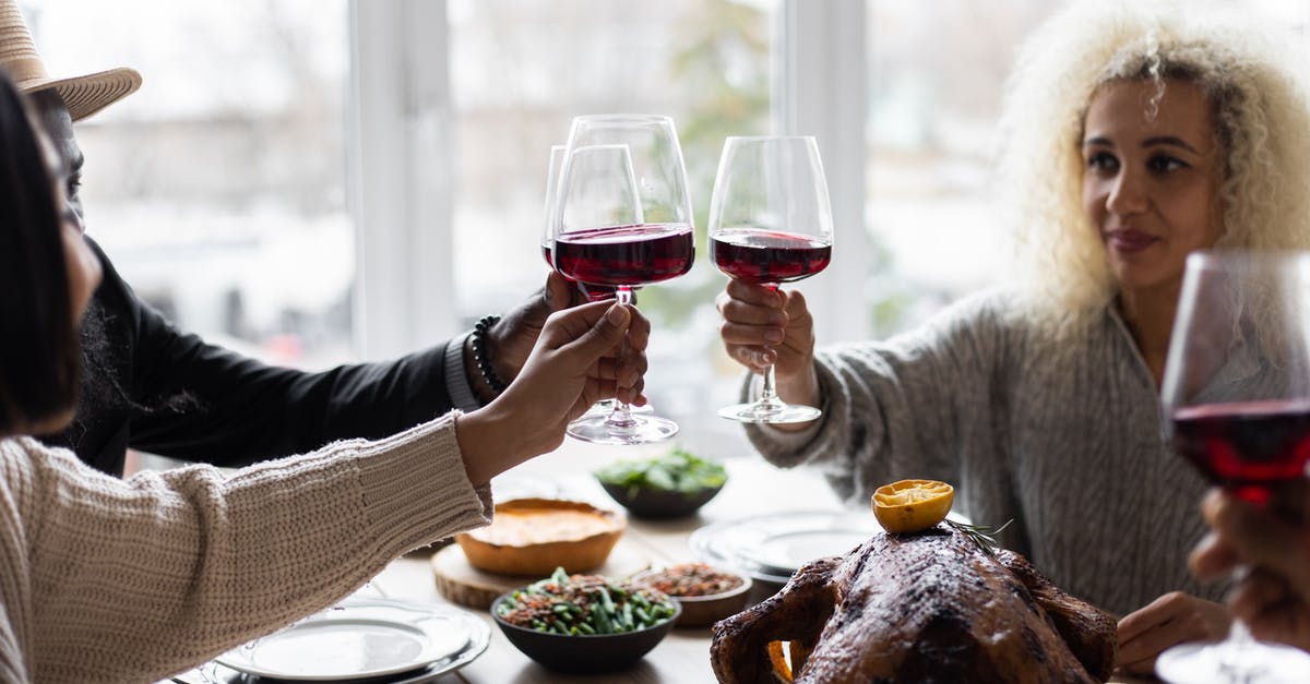 Turkey Dinners For A Group of 140 People - Multiethnic people clinking glasses having dinner