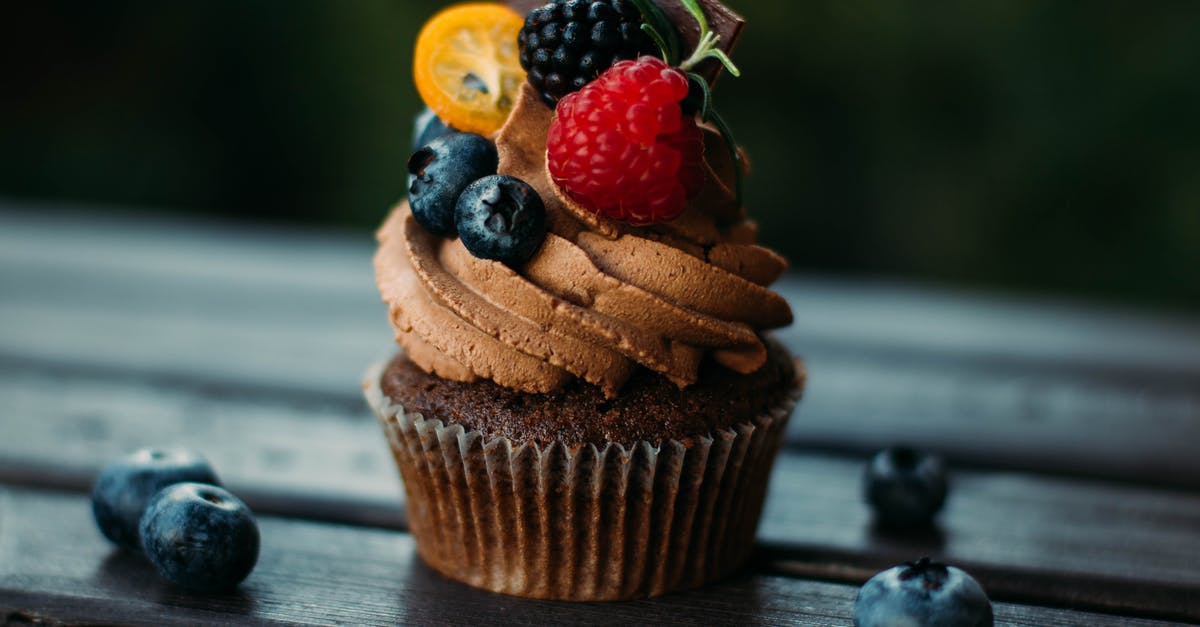 Turn leftover icing into buttercream icing? - Brown Cupcake With Blue and Red Berries on Top