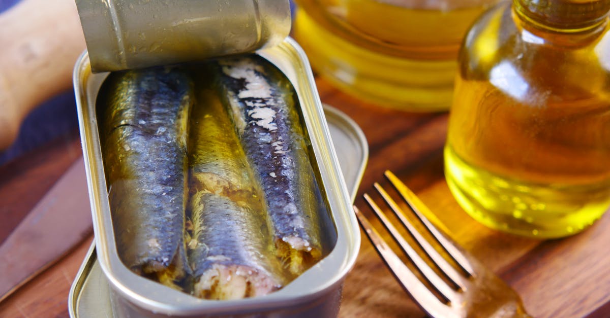 Unopened canned sardines behaving strangely but not expired - Close-Up Shot of Sardines in a Can