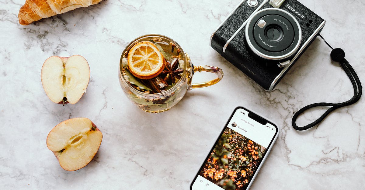 Upside-Down Lemon Squares? - A Cup of Ta with Lemon Lying Next to a Camera and a Phone