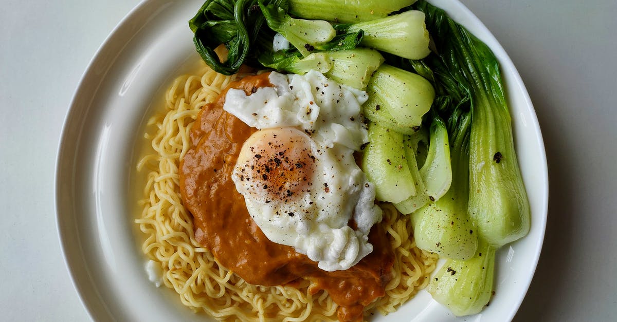 Use of ground beef in Chinese food - Delicious noodles with bok choy and fried egg on plate