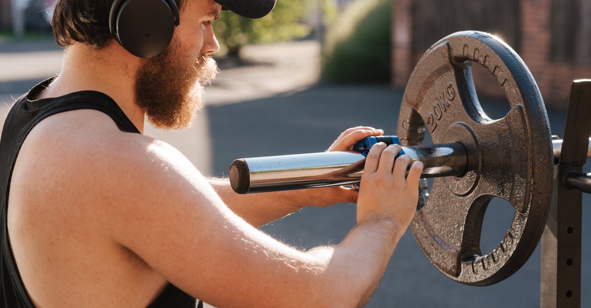 Using a Dutch Oven as a Heavy Skillet replacement - Crop hipster sportsman preparing barbell before exercising on street