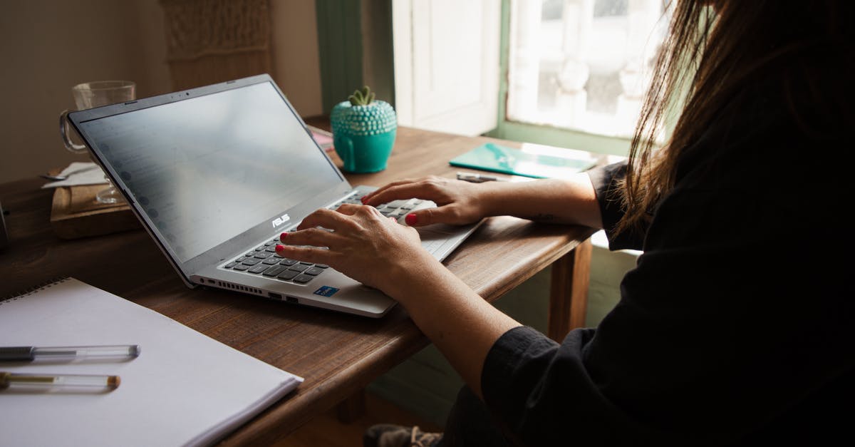 Using a large pot/pan on a smaller burner - Woman in Black Long Sleeve Shirt Using Macbook Pro on Brown Wooden Table