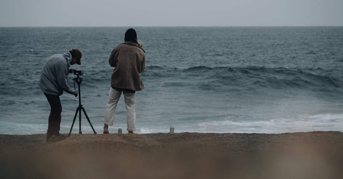 Using a vacuum sealer to marinate? - Unrecognizable men photographers in casual clothes standing on beach and taking photo on professional photo camera of stormy sea in daylight