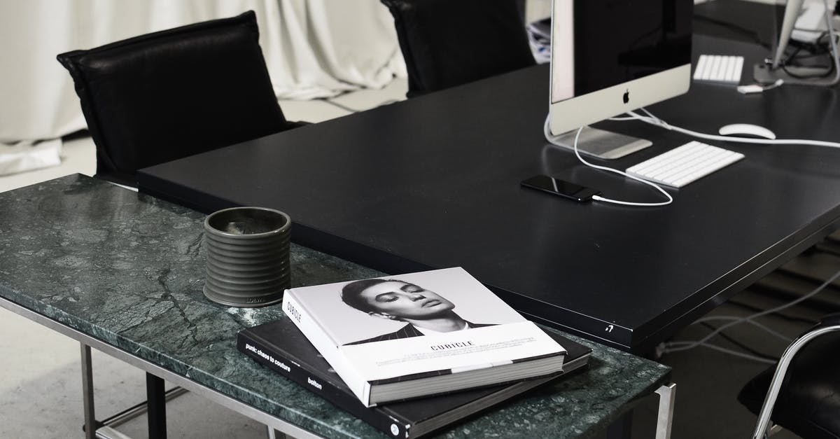 Using acidity to brighten simple sides like purees - Modern computers and smartphone placed on black table near marble table with books in contemporary workspace