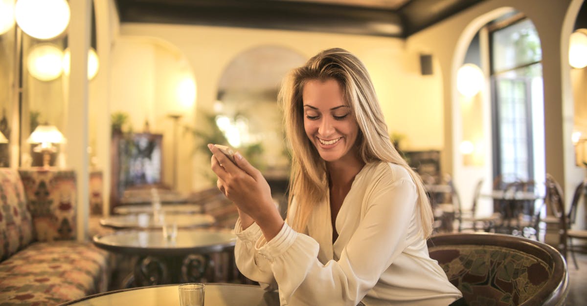 Using cast iron on a glass range - Cheerful female having drink in elegant bar