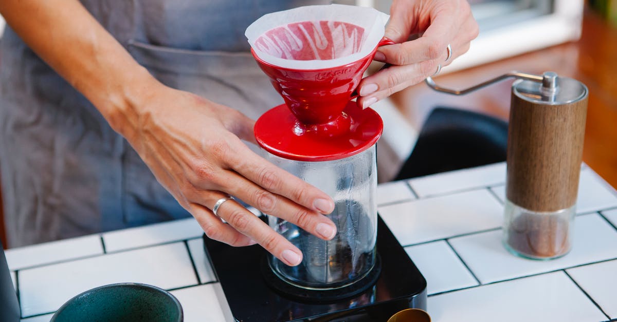 using coffee filters to filter home pressed olive oil - Woman barista preparing fresh alternative coffee in cafe