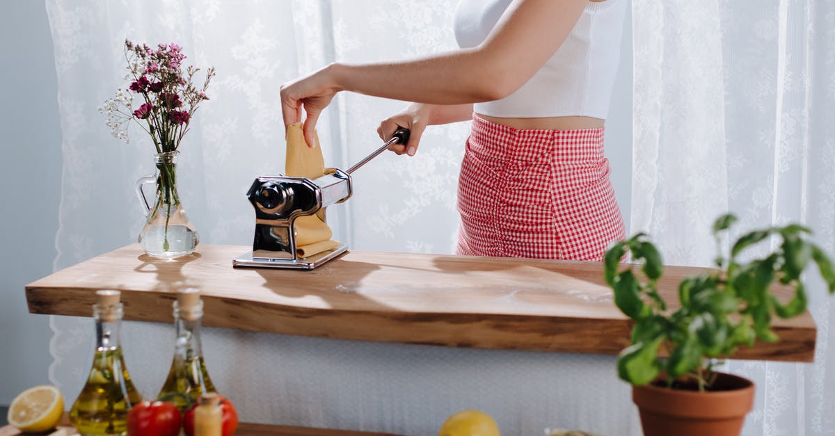 using cooking propane torch held sideways - Woman Using Pasta Maker