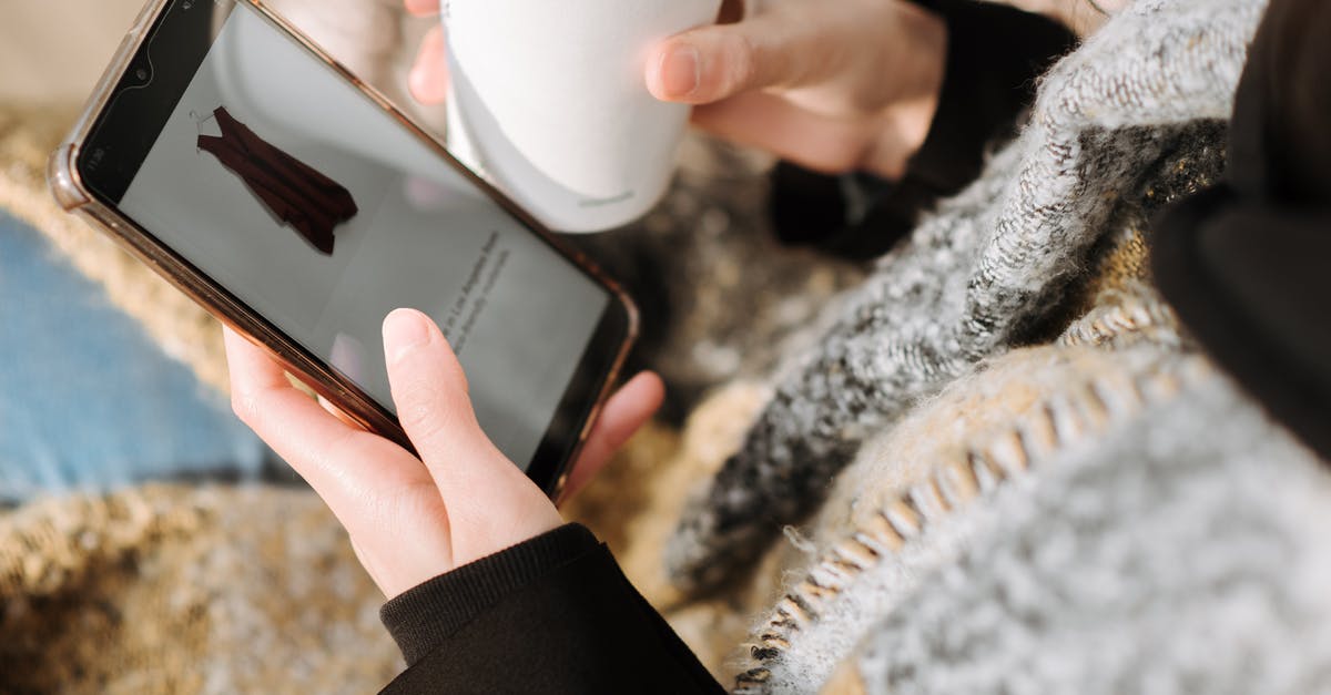 Using Frozen Fries as a Component: How to Dress Them Up? - From above of crop anonymous female purchaser with takeaway hot drink choosing dress on cellphone screen during online shopping