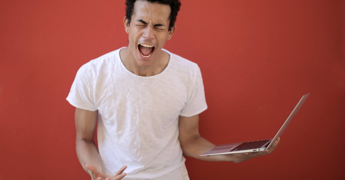 Using Instant Pot Duo Crisp to mimic smoker-cooked pork shoulder - Guy with opened mouth and closed eyes screaming madly while standing with laptop against red background