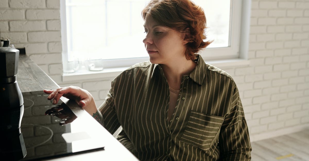 Using low oven temperature to accelerate proofing - Woman Using Black Electric Stove