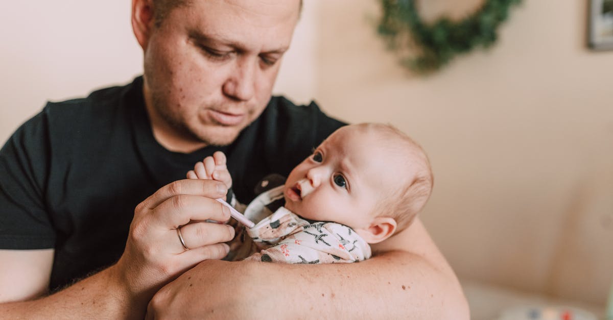 Using low oven temperature to accelerate proofing - Man Using Thermometer to Check the Baby's Temperature