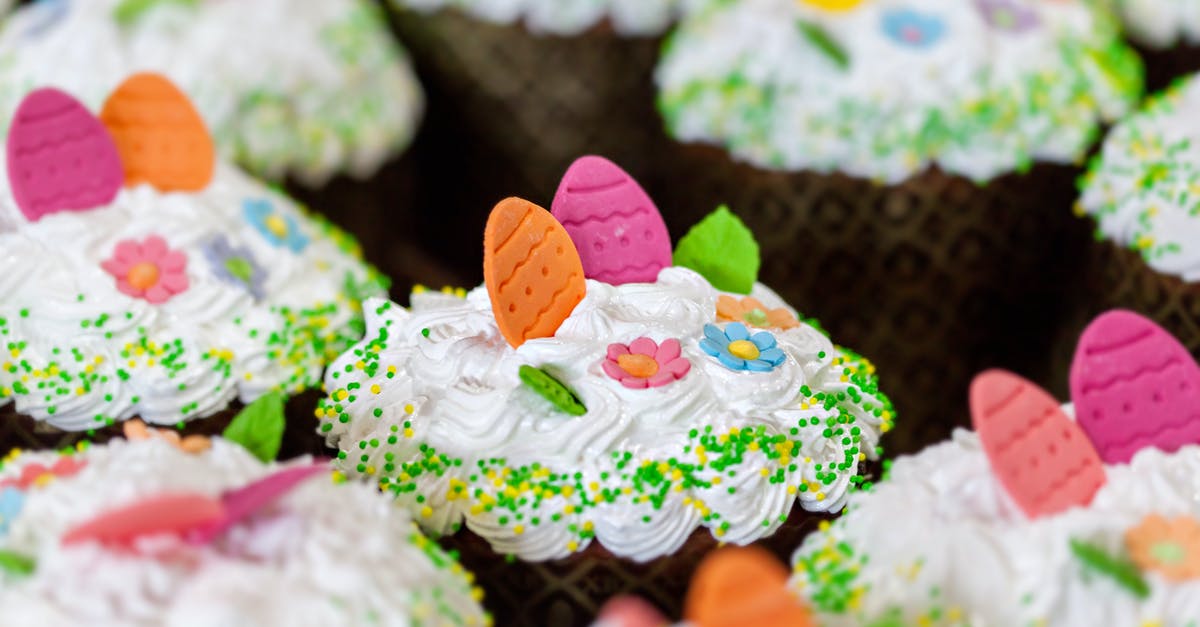 Using manual egg beater to cream eggs and sugar - Tasty desserts with whipped meringue cream and sprinkles with colorful decorative eggs on top in confectionery