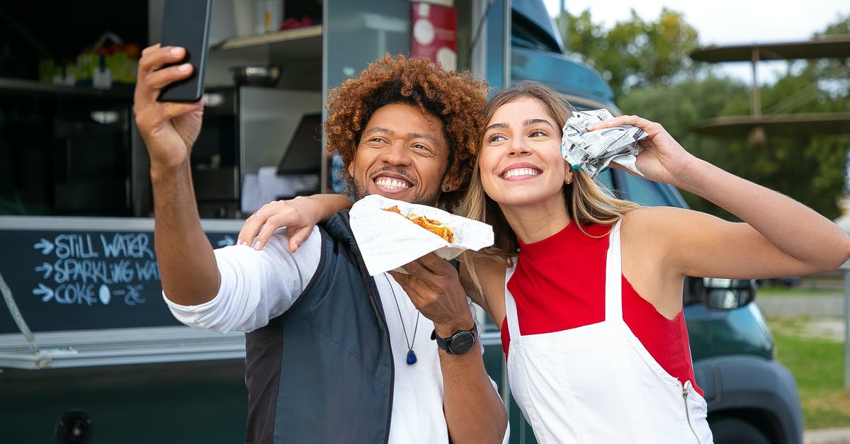 using polenta to make hamburger - Happy multiethnic friends with burgers taking selfie near food truck