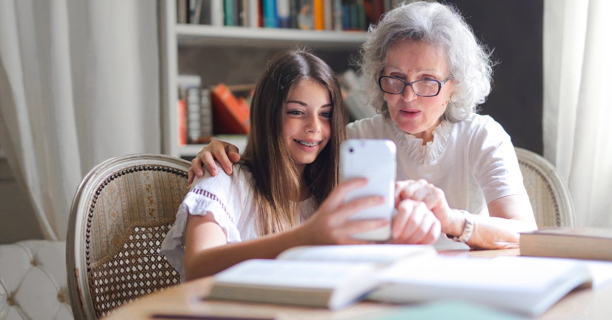 Using salmon in 2 days, freezer or fridge? - Photo of Woman Showing Her Cellphone to Her Grandmother