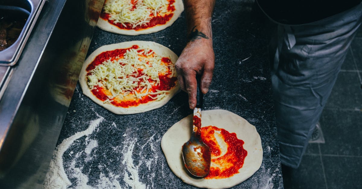 Using sugar when making pizza dough - Person Spreading Tomato Sauce onto Pizza Dough