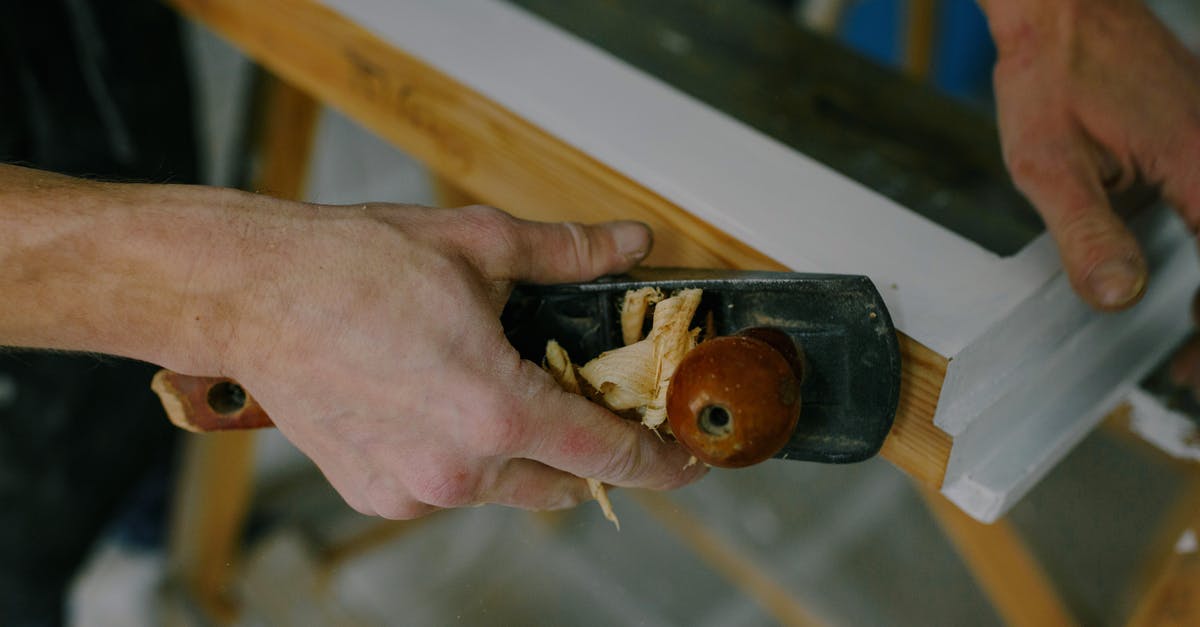 Using the bone from a spiral cut ham - Crop carpenter working with window frame using plane