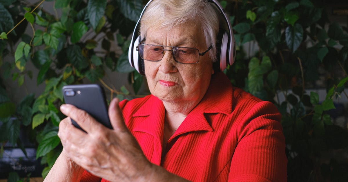 Using the right acid for red curry - Focused aged woman browsing smartphone while listening to song