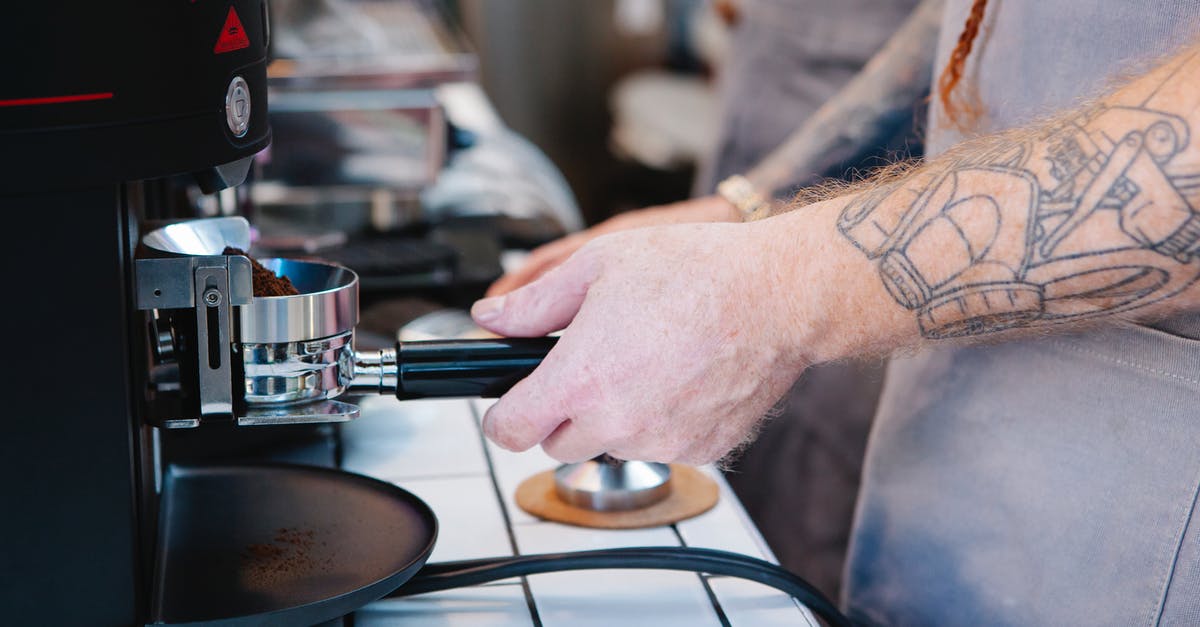 Using whey from yogurt to make ricotta - Tattooed man preparing coffee with coffee machine