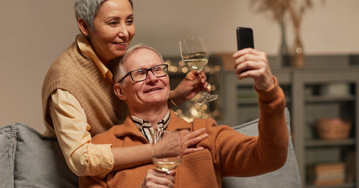 Using white wine in the cooking - Couple Taking a Selfie