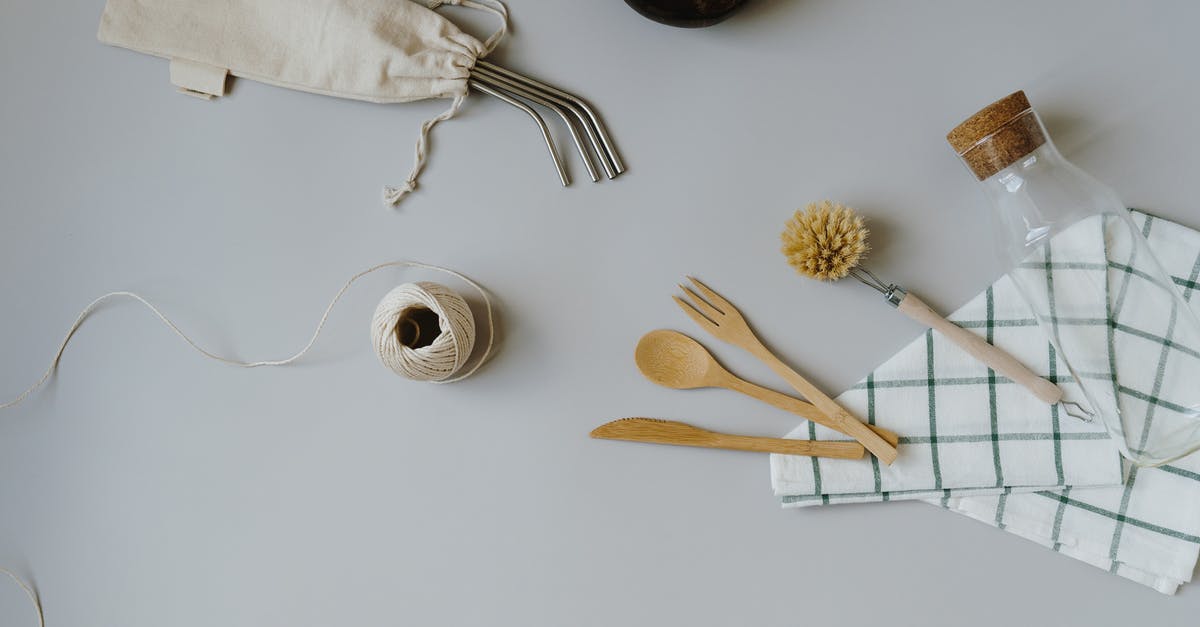 Utensil materials - plastic, metal or wooden? - Set of dental tools and cutlery near glass bottle