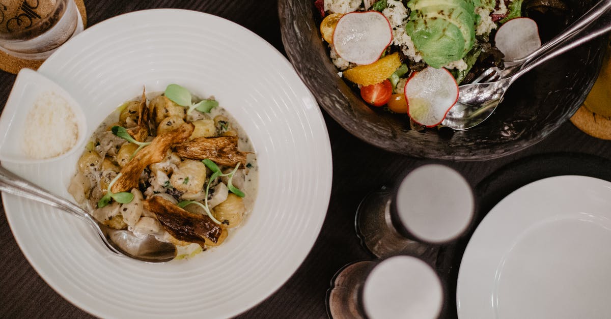 Utensil that forms meat into cylinders - Top view of plate with stewed vegetables and meat placed on black table near bowl with fresh salad and jars with spices Utensil that forms meat into cylinders - Top view of plate with stewed vegetables and meat placed on black table near bowl with fresh salad and jars with spices