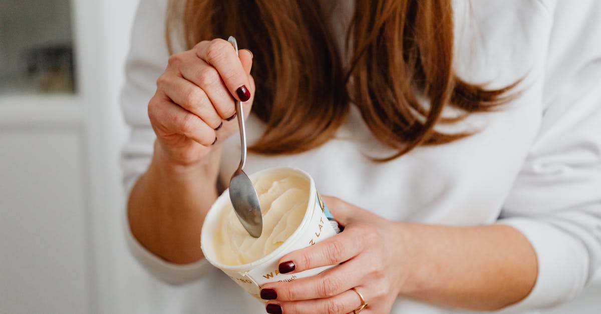 Vanilla extract cups vs spoon - Close-Up Photo of a Woman's Hands Getting Ice Cream in a Cup