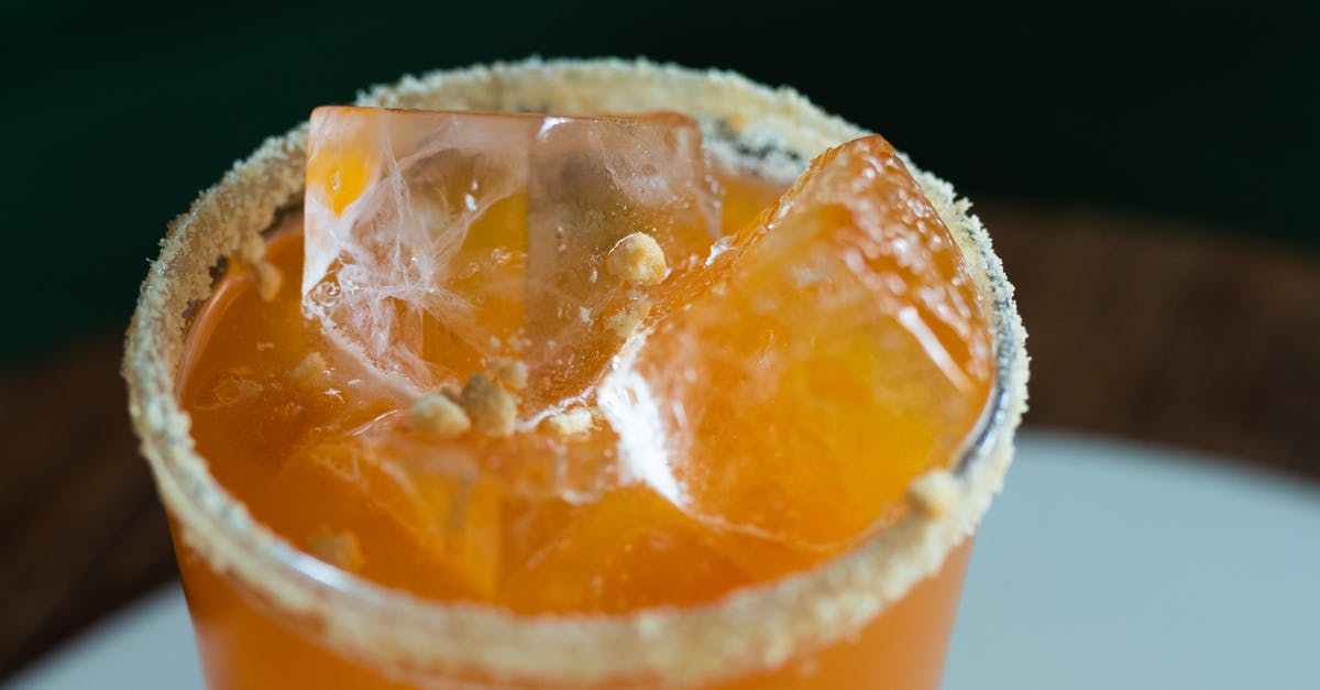 Vanilla Extract with and without alcohol - Orange Juice in Clear Drinking Glass