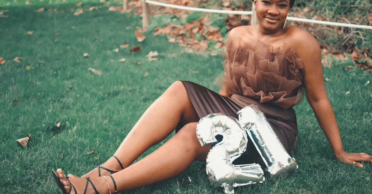 Vegemite in a tube? - Woman in Brown Tube Dress Sitting on Green Grass Field