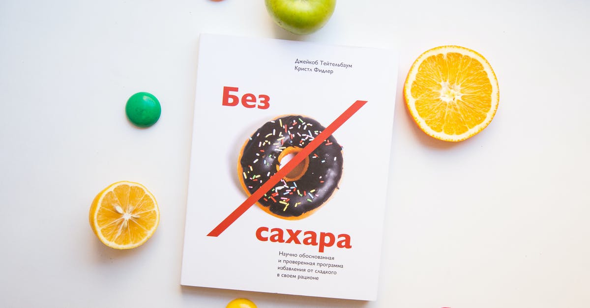 Vegetarian gluten free savouries - Top view of various fresh fruits and colorful magnet arranged on white background with book about proper nutrition