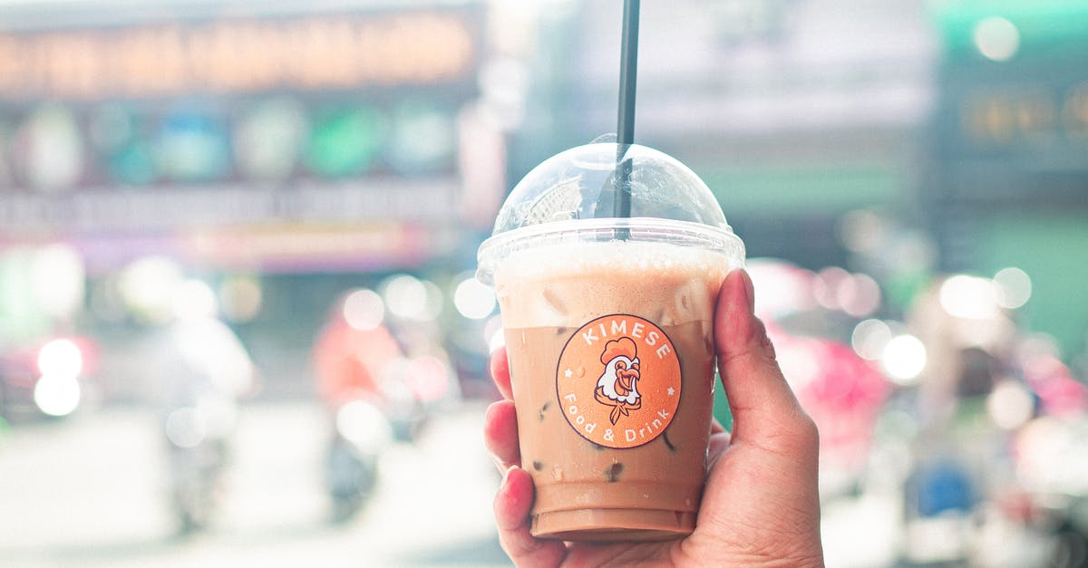 Vietnamese Coffee (cocktail) - what to sub for condensed milk? - A Person Holding a Plastic Cup with Iced Coffee