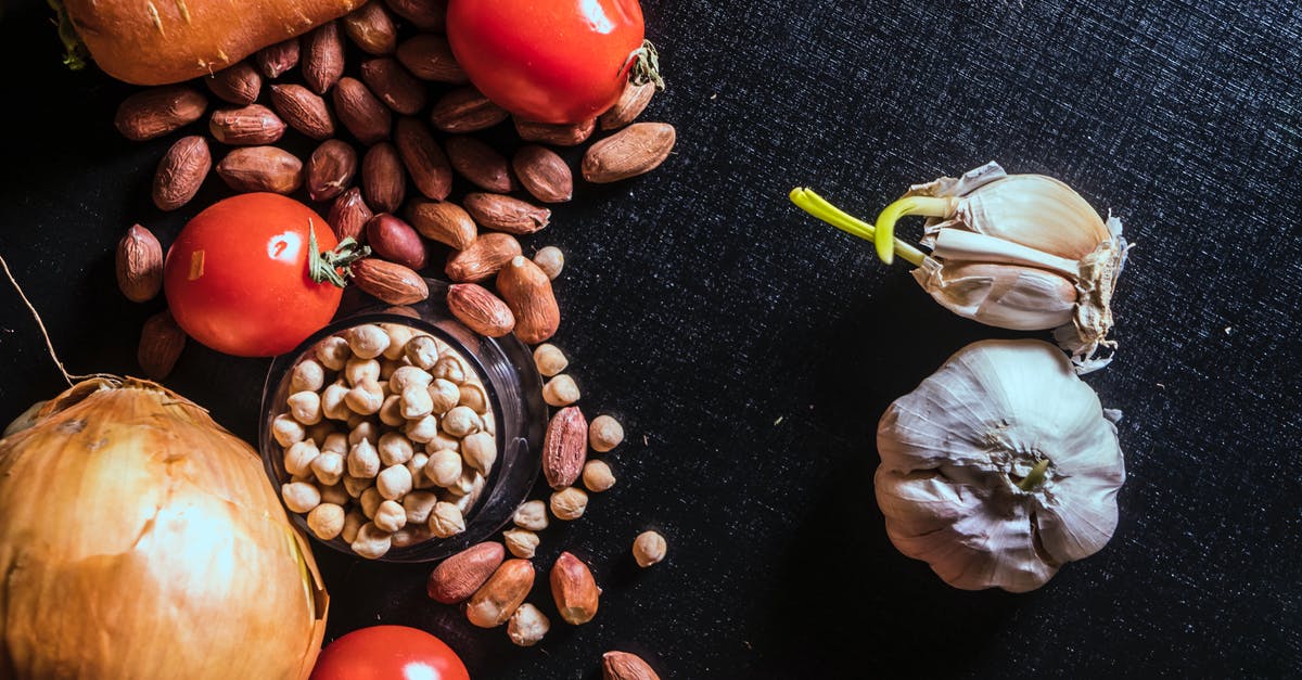 Vinegar softens the bite of raw onions? - Variety of Spices and Vegetables on Black Surface