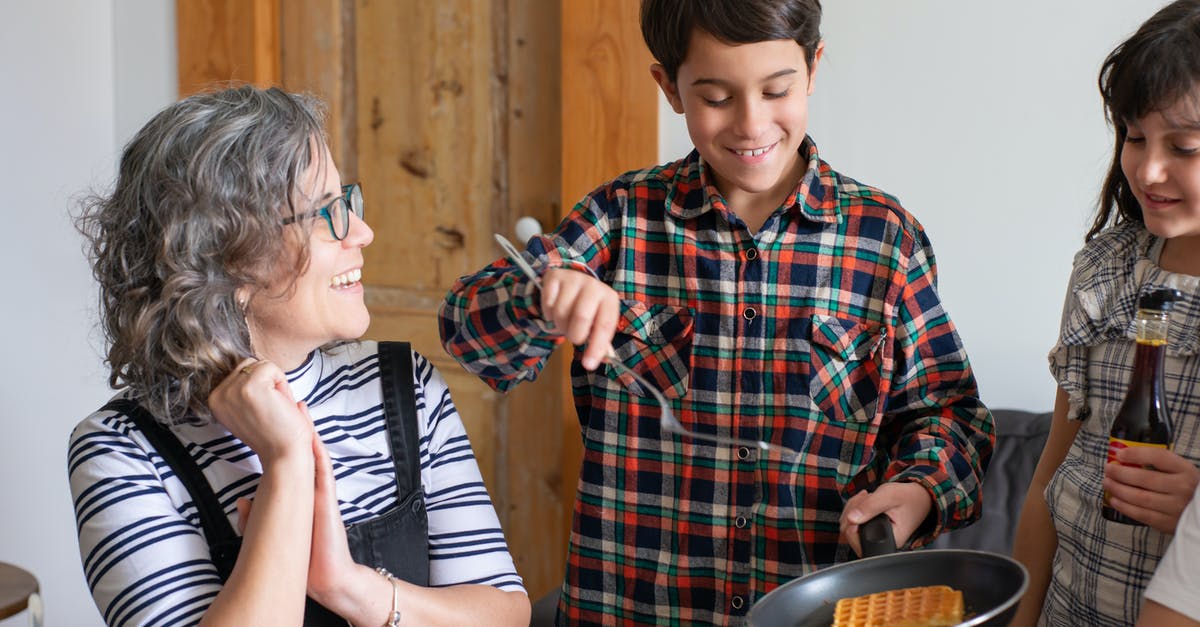 waffle cones for serving lattes - A Young Boy in Plaid Long Sleeves Holding a Cooking Pan with Waffle