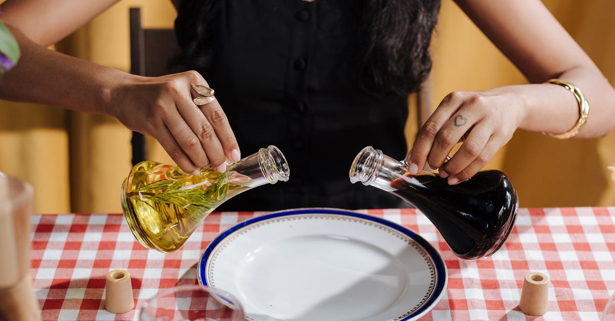 Want vinegar taste! - Woman Holding Vinegar and Olive Oil Bottle over Dish