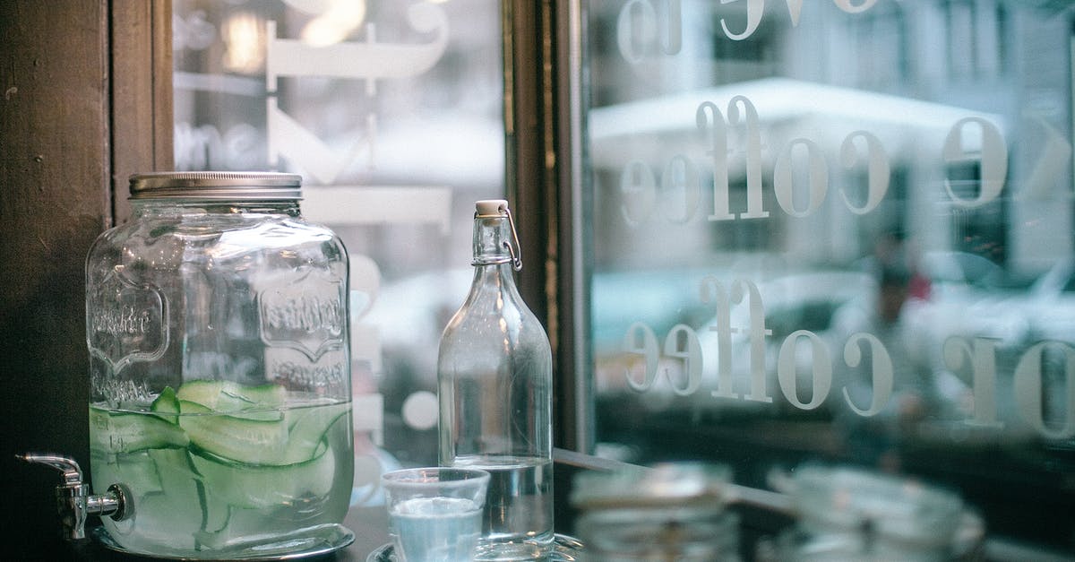 Water + Sugar Solution Preserves Bread? - Glass jar of cucumber infuse water and bottle of mineral water with glass placed on wooden table with sugar jars located in urban cafeteria