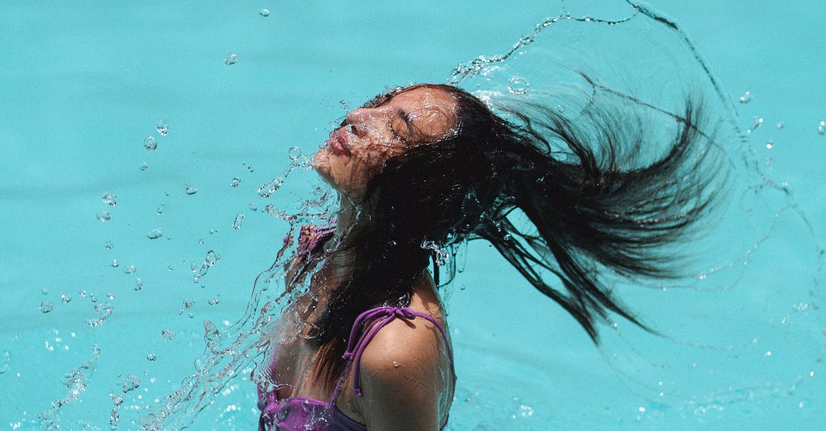 Water collects around cooked idlis in my steamer - Slim waving hair in blue water of resort pool