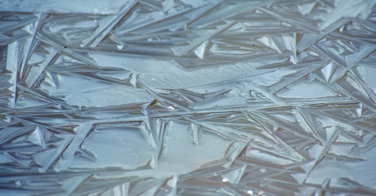 water temperature affecting bread rolls texture! - Full frame background of water in winter covered with slightly frozen clear ice with textured structure of surface