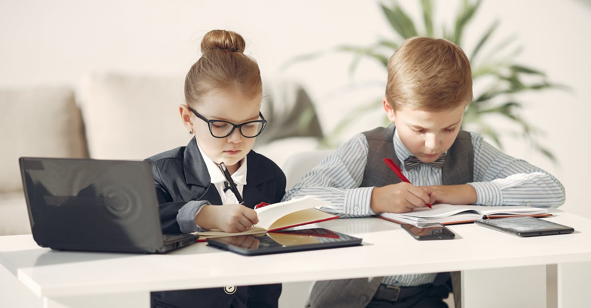 Watermelon - picking and managing them during heat - Cute business children in uniform using laptop and writing information in planners while making up startup strategy in modern workspace