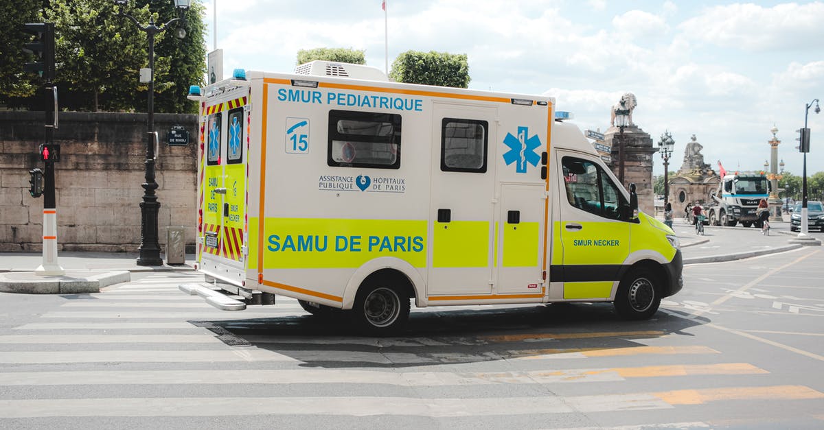 Way to Prevent Rusting Racks? - Ambulance driving along road in sunny city