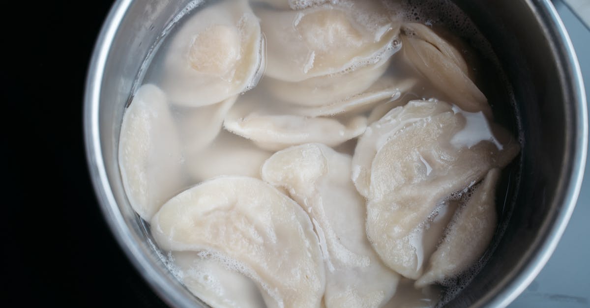 Ways to displace liquids while cooking - Dumplings Cooking in the Stainless Cooking Pot with Water