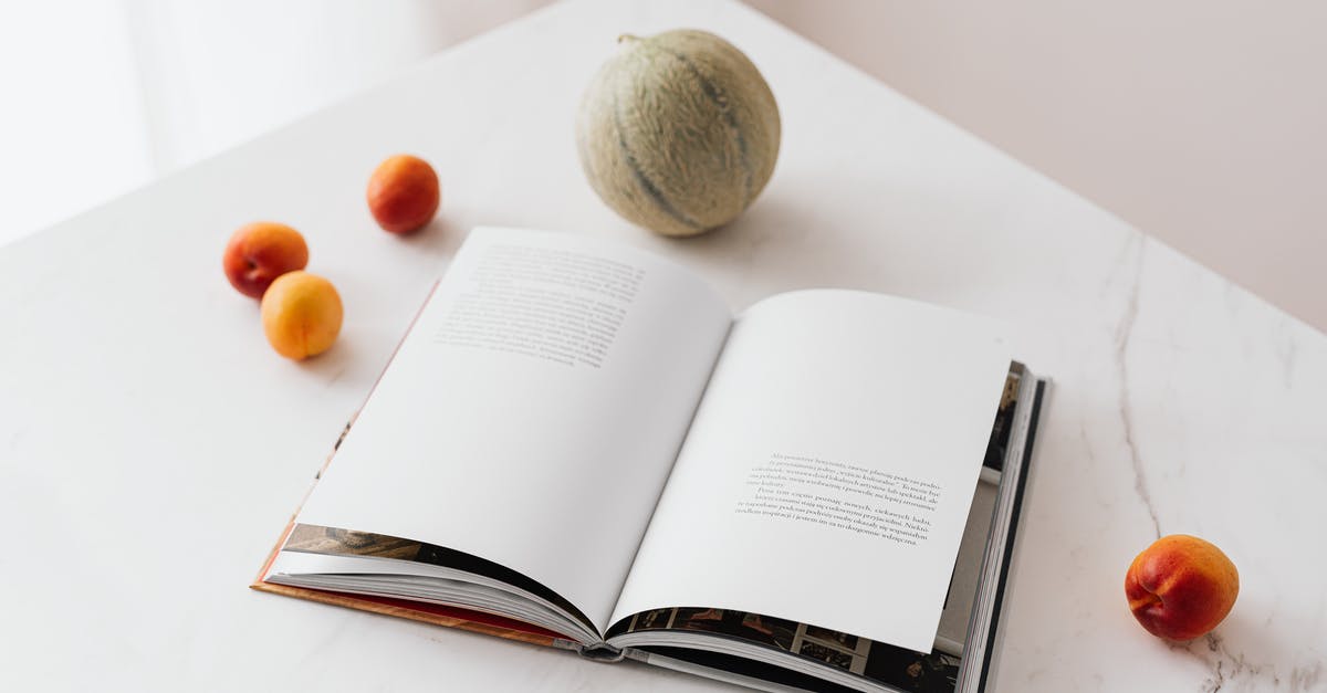 Ways to learn to season food correctly? - Fresh fruits scattered on table near opened textbook