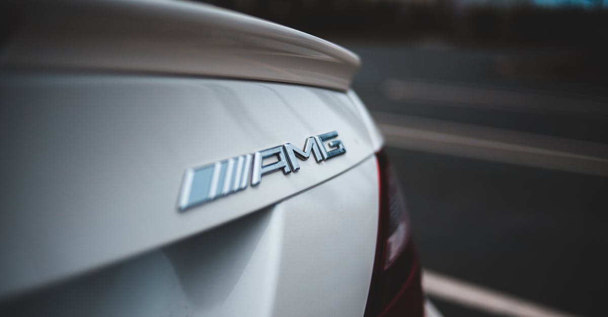 Ways to speed up this chai recipe? - Closeup of chrome logotype on trunk of new shiny white modern car driving on asphalt road