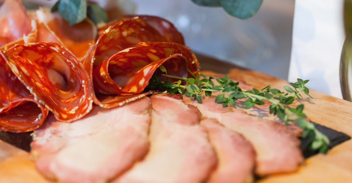 wet cured ham spoilage - Slices of Meat Item with Green Leaves