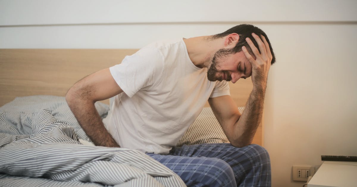 What's an effective method to strain liquids? - Young man in sleepwear suffering from headache in morning